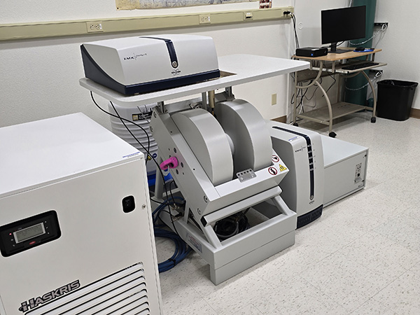 a large piece of equipment sits on the floor of a lab. 