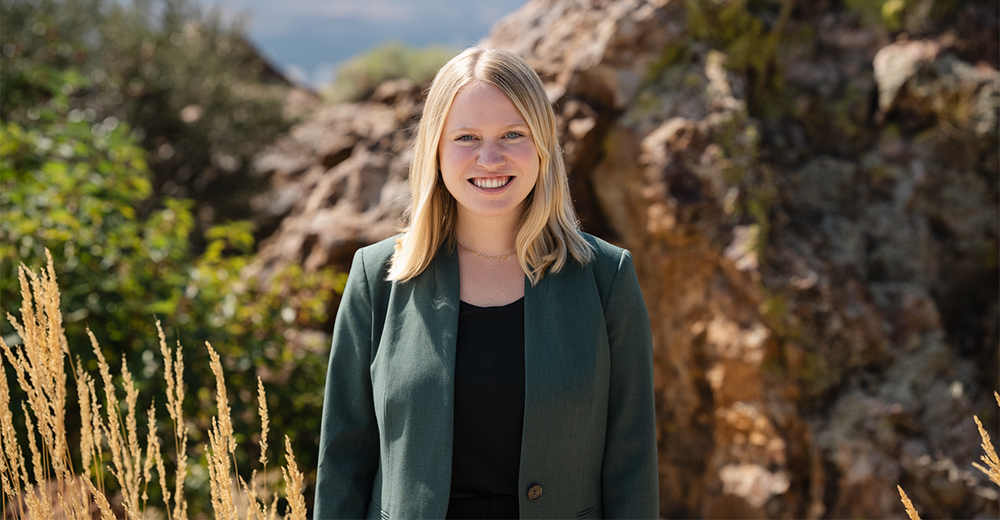 Picture of Andrea Gordon Outside in front of desert landscape.