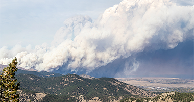 Ashfall Blurb Image Wildfire smoke and ash plume on a mountain top.