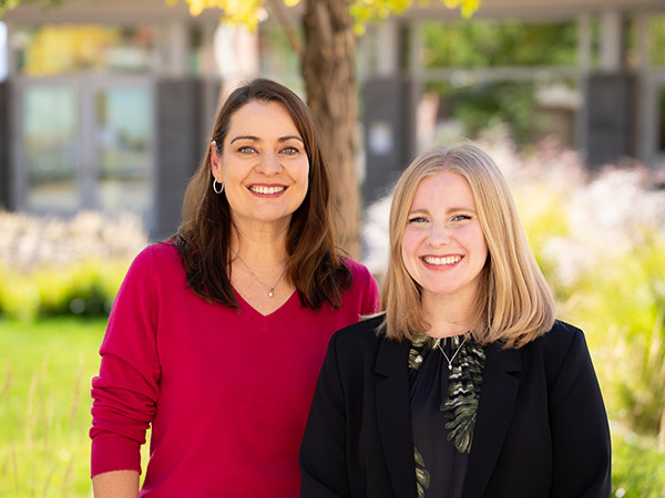 Ashley and Vera posing together smiling outside on the DRI Reno Campus