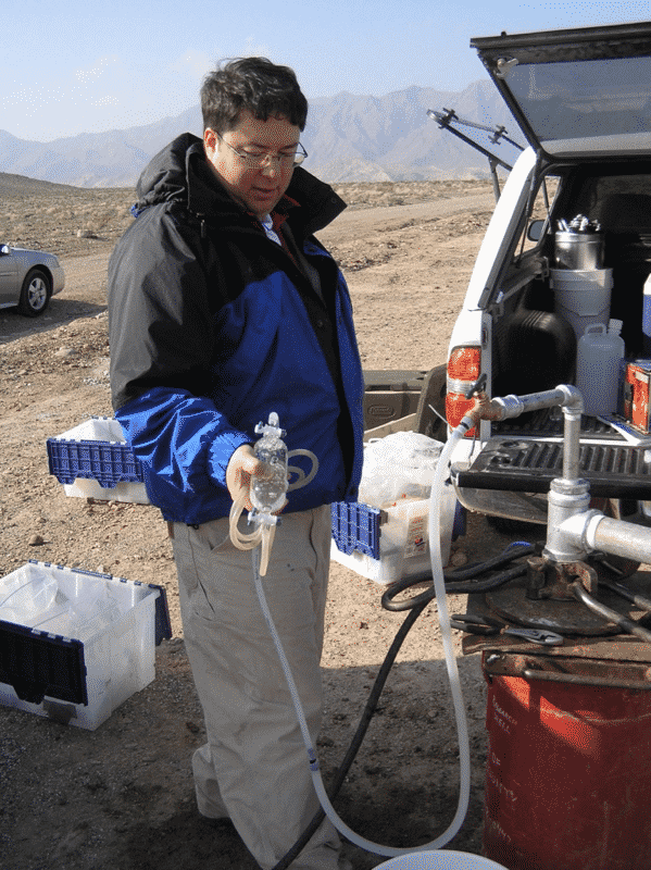 DRI scientist Duane Moser collecting dissolved gas samples from the main project borehole near Death Valley, CA.