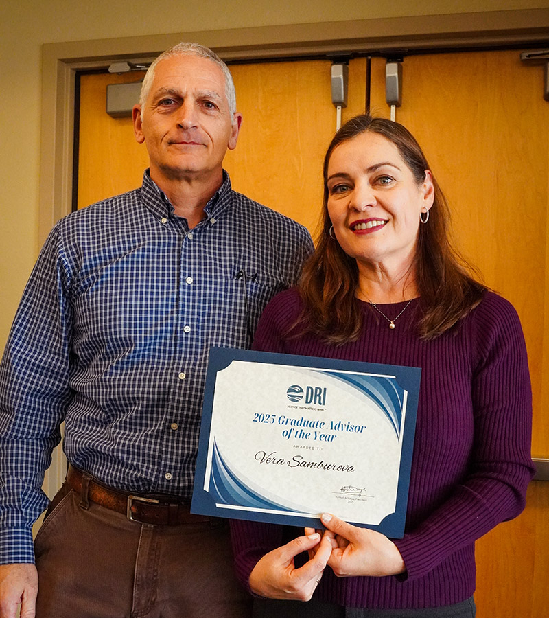 Vera Samburova holding her award for 2025 Graduate Advisor of the Year.