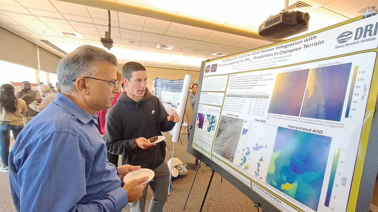 Two men looking at a poster.