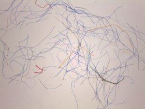 A microscope photo of colorful microfibers.