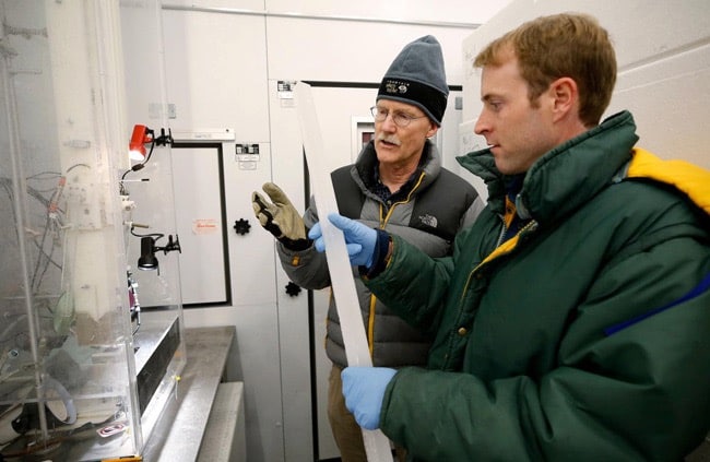 Researchers holding an ice sample.