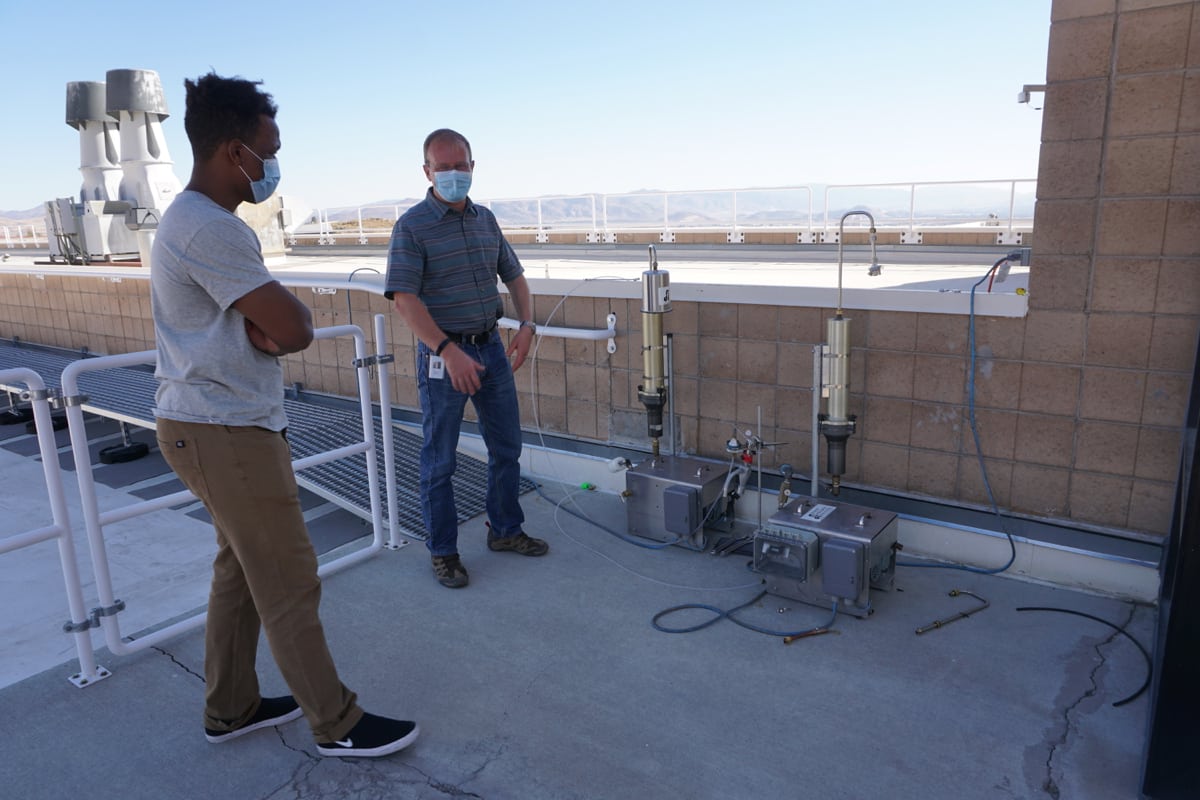 DRI researchers collect data from air quality monitoring station on DRI rooftop