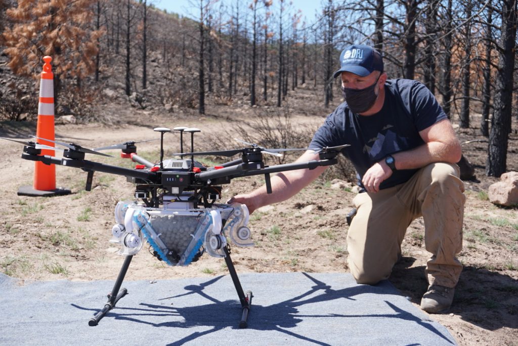 Jesse Juchtzer of the Desert Research Institute prepares the drone for a reseeding flight at the Loyalton Fire burn area on April 22, 2021.