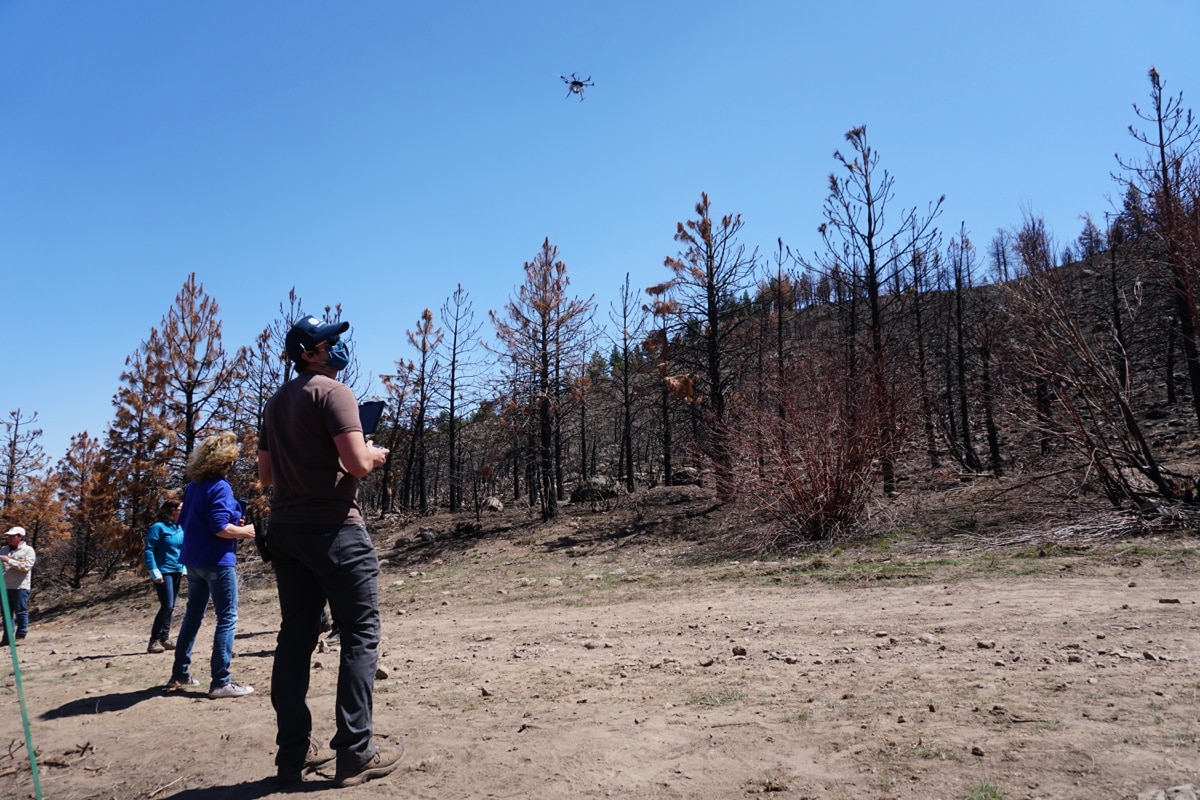 Patrick Melarkey of the Desert Research Institute flies the drone during a reseeding flight at the Loyalton Fire burn area on April 22, 2021.