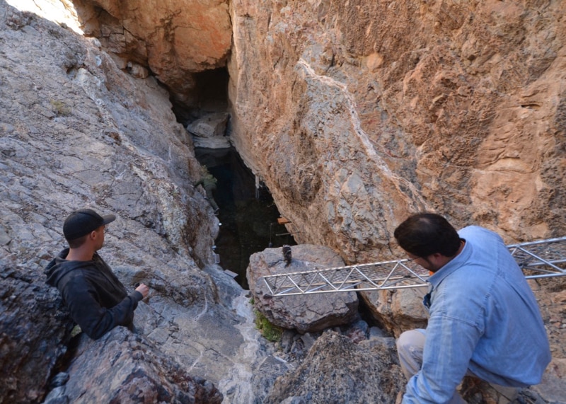 DRI researchers help NPS officials move scaffolding at a visit to Devil's Hole.