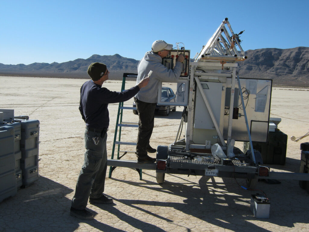Scientists inspect dust measurement device