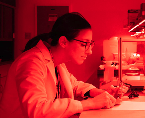 Scientist working in red light in the Luminescence Lab at DRI