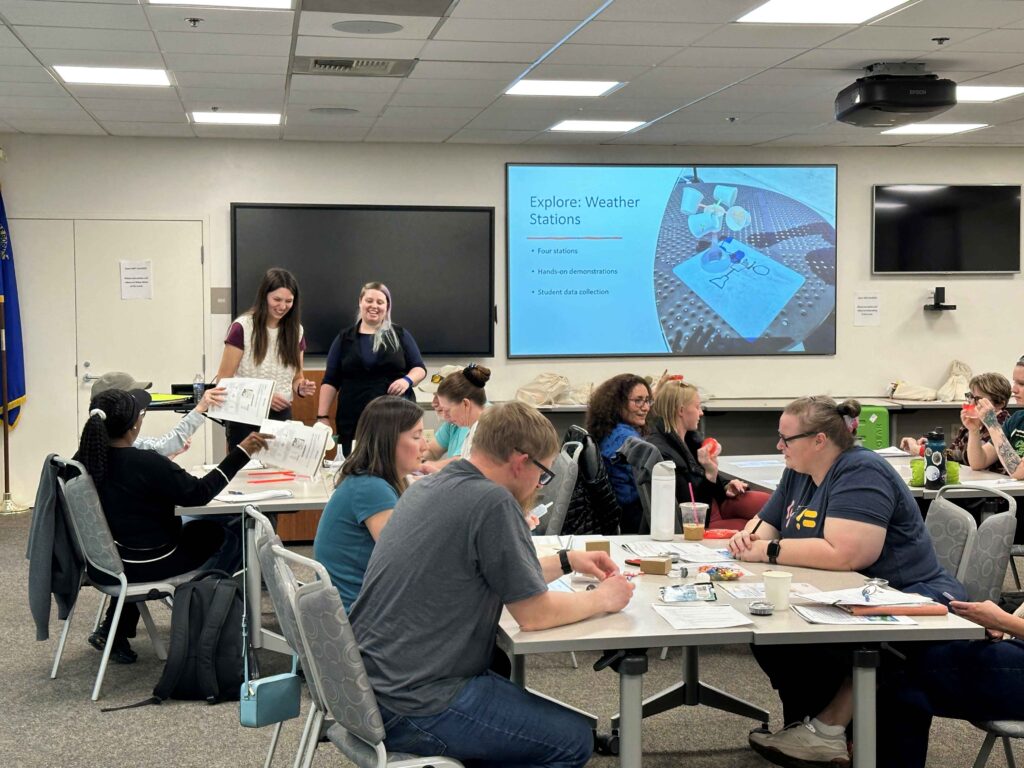 A group of people working in a classroom.