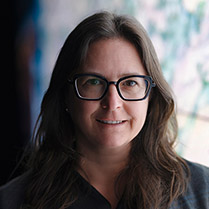 Headshot of Jessica wearing glasses and smiling. 