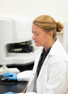 female scientist working on computer in lab