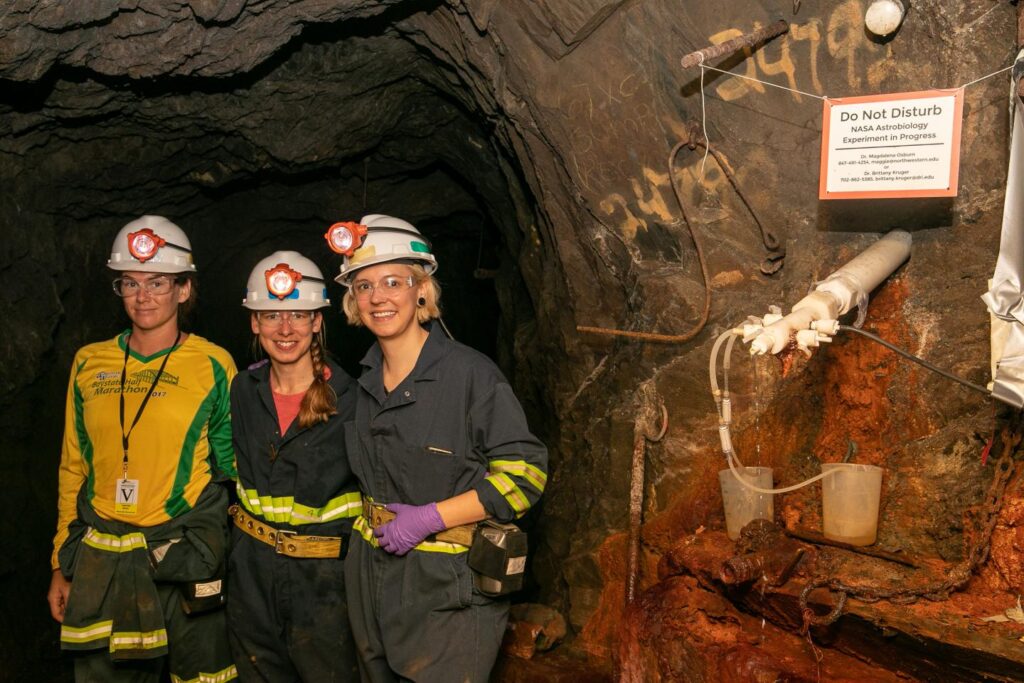 DeMMO field team from left to right: Lily Momper, Brittany Kruger, and Caitlin Casar sampling fracture fluids from a DeMMO borehole installation