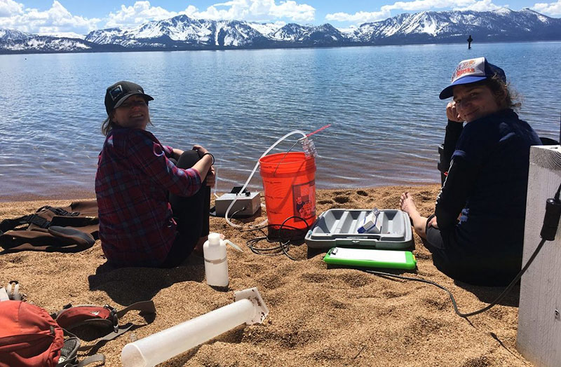 scientists sitting on the beach at Lake Tahoe