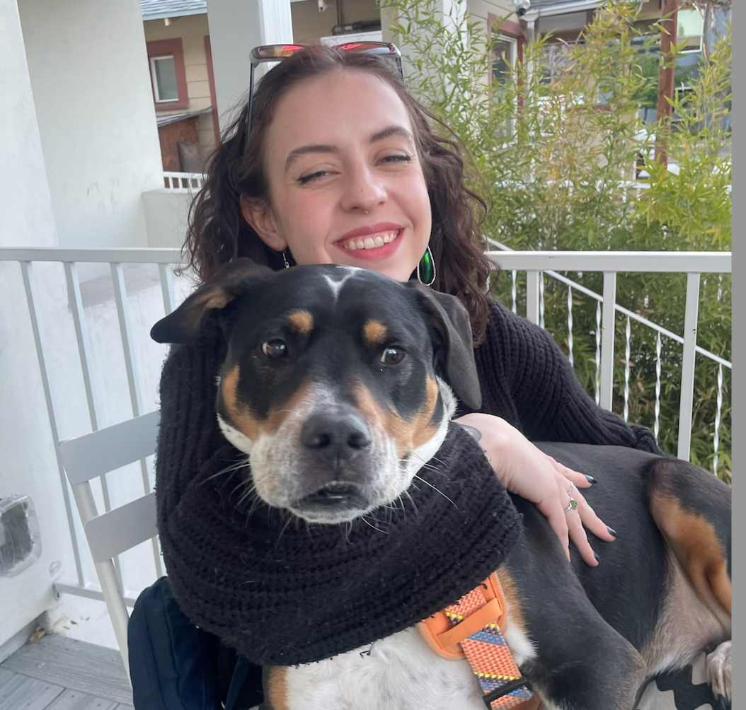 A woman holding a dog.