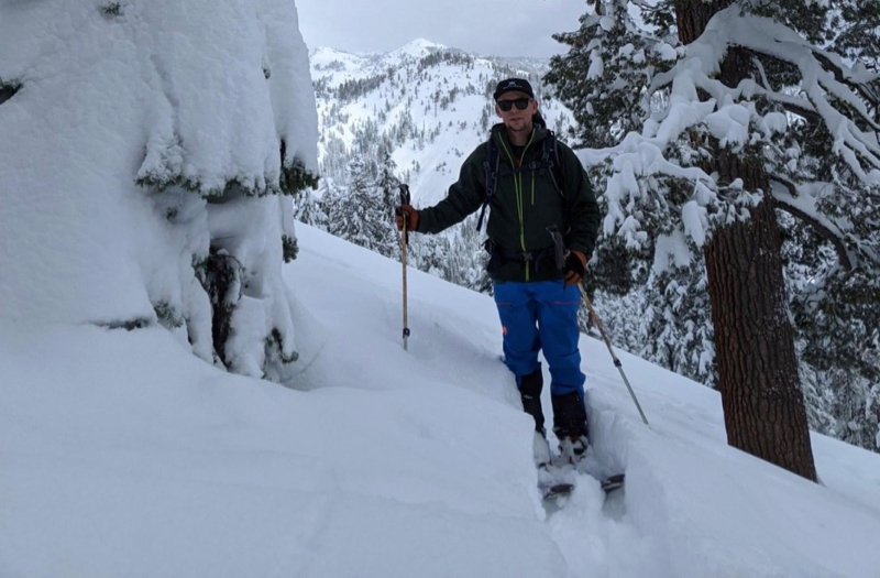 DRI scientist Dan McEvoy skis through a snowy landscape.