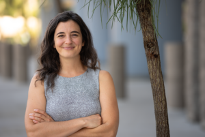 Monica Gehrig outside with arms crossed and smiling at the camera.