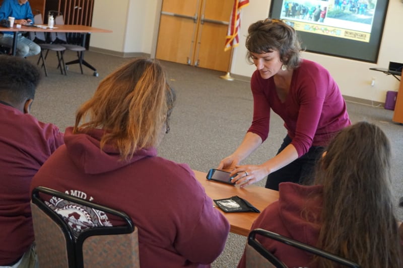 Youth Day organizer Meghan Collins of DRI instructs students in the use of Stories in the Snow kits. October 2018. Credit: NWAL/DRI.
