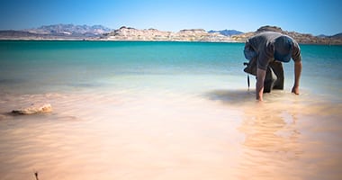 Dr. Kumud Acharya sifting through water