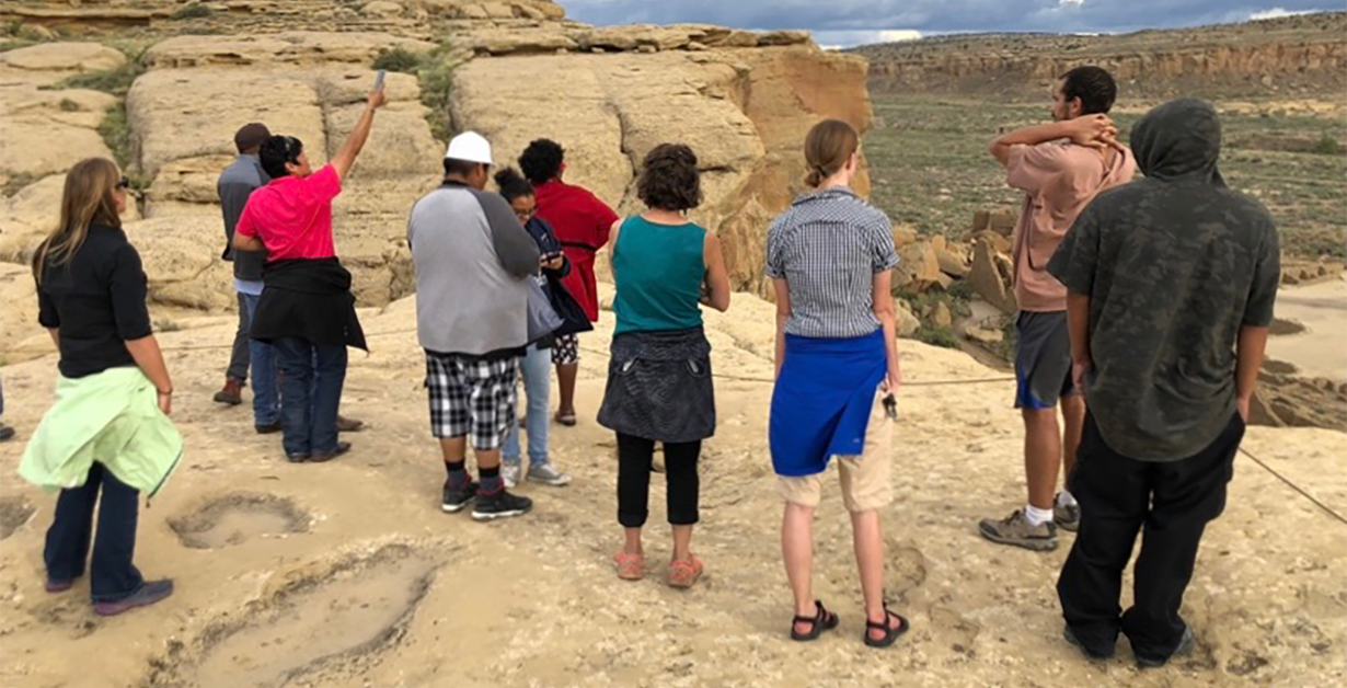 Teachers with students at an outdoor lesson overlooking a canyon.