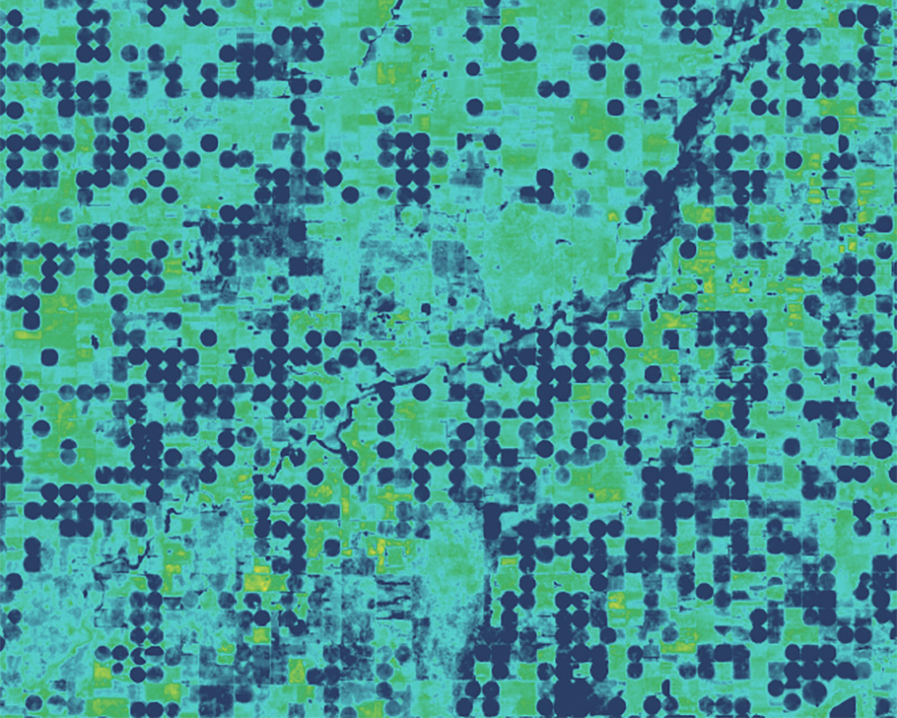 Satellite image from OpenET that displays a map of blue and green circles.