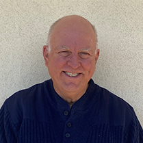Stephen Pyne smiling with a plain white background.