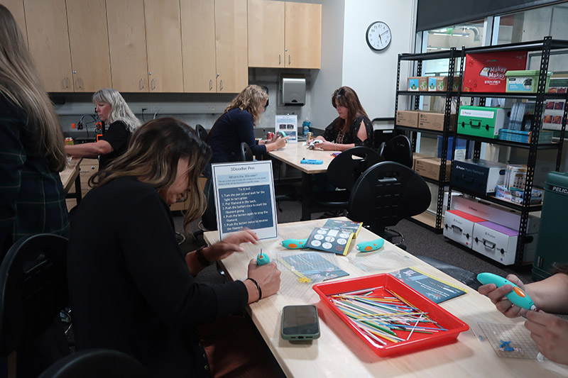 Woman holding a pen like device for a craft.