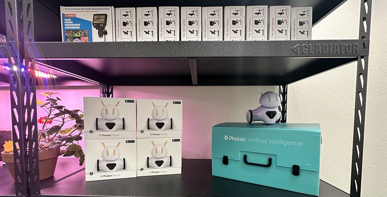 A shelf in the STEM CoLab featuring robots and items available to check out. 