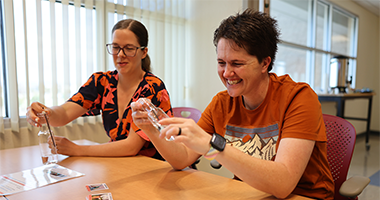 Teachers sitting at a table enjoying a professional development lesson.