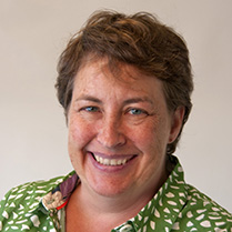 Headshot of Sarah McCaffrey in a green shirt and smiling at the camera. 