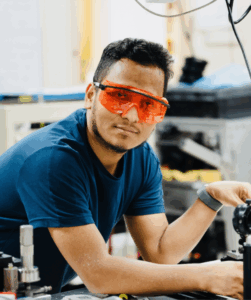 Photo of Prakash Gautam wearing safety glasses in his lab.