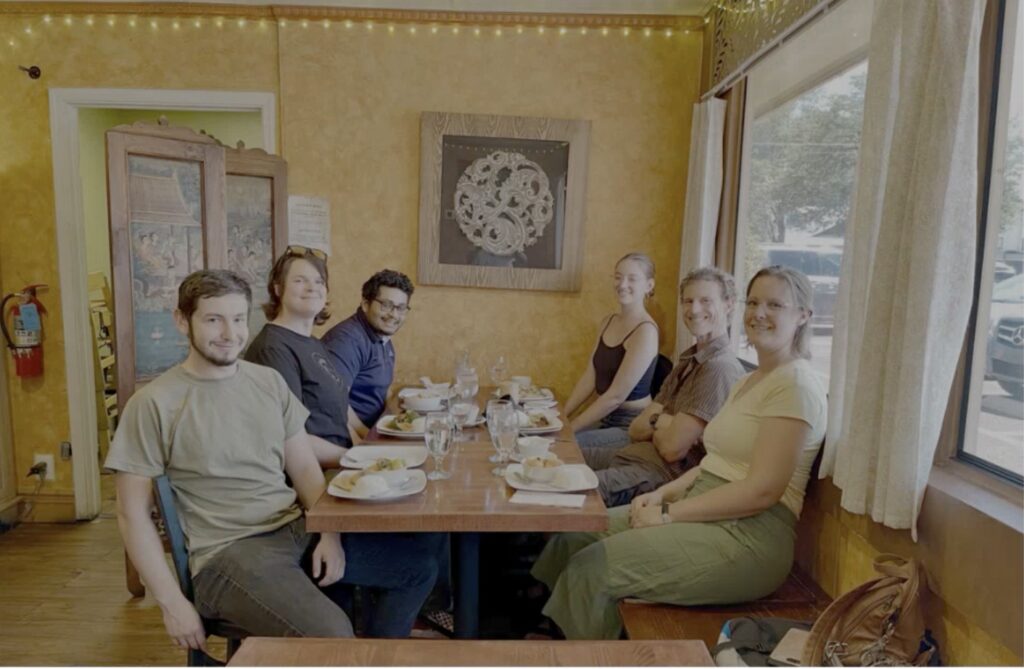 Group of student researches eating at a table.