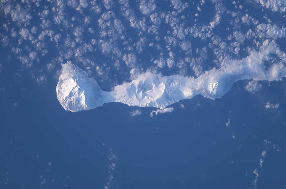 Satellite Image of Simushir Island covered in snow and ice surrounded by the Pacific Ocean.