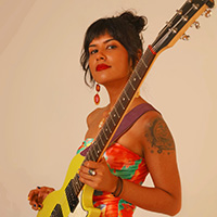 Headshot of Sonia Barcelona holding a yellow guitar. 