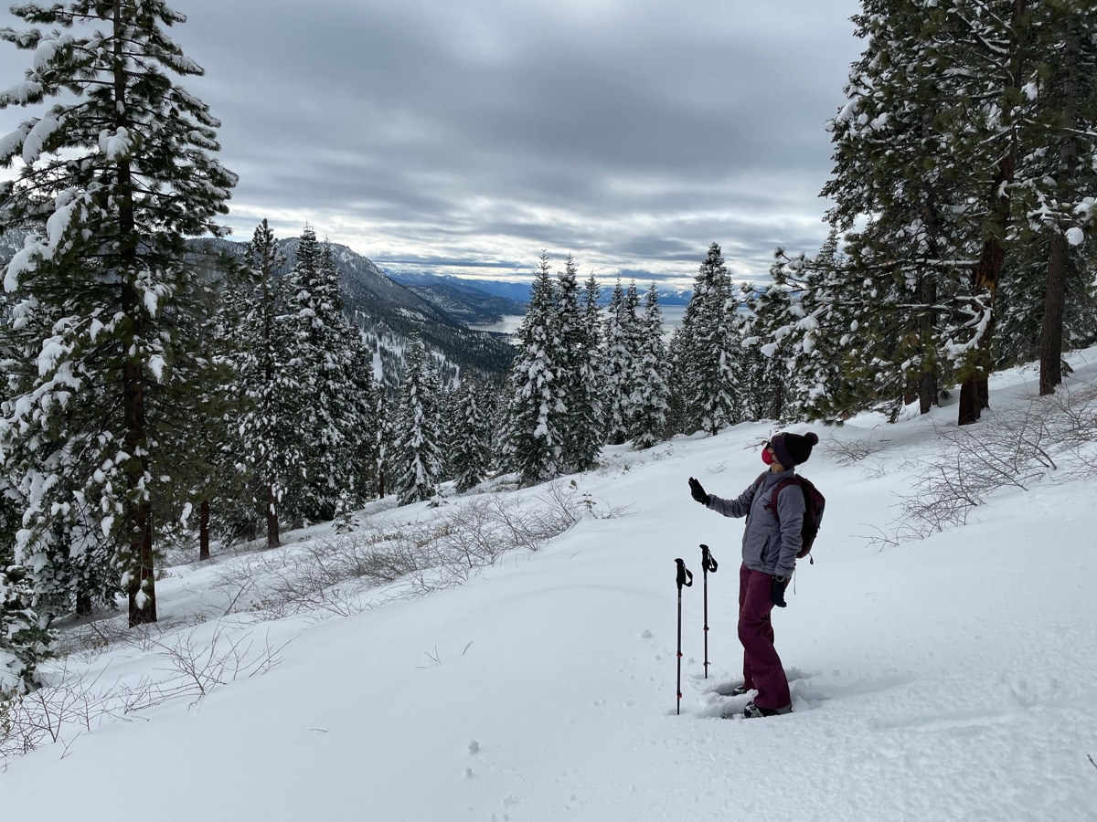 DRI scientist Monica Arienzo collects data for the Tahoe Rain or Snow project with Lake Tahoe in the distance.
