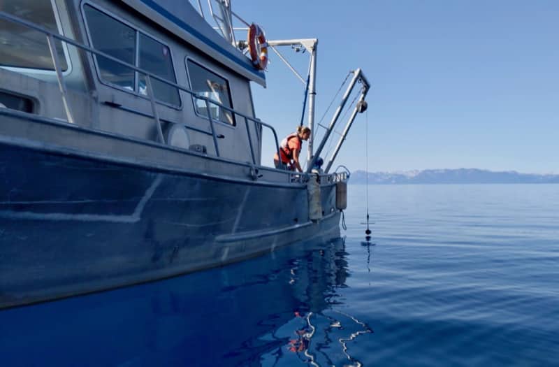 Scientist conducts a Secchi disk measurement at Lake Tahoe