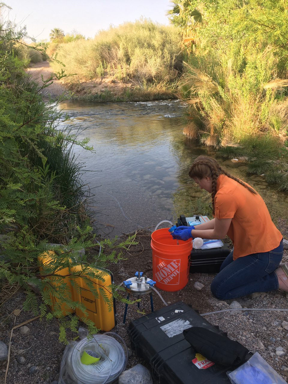 scientist samples mainstem in water