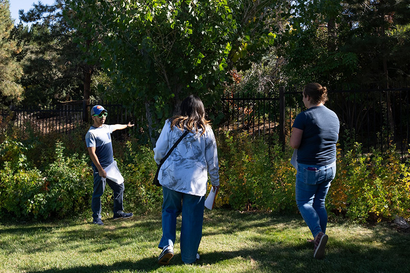 internship careers page An instructor points to a wooded area with trees as students look on.