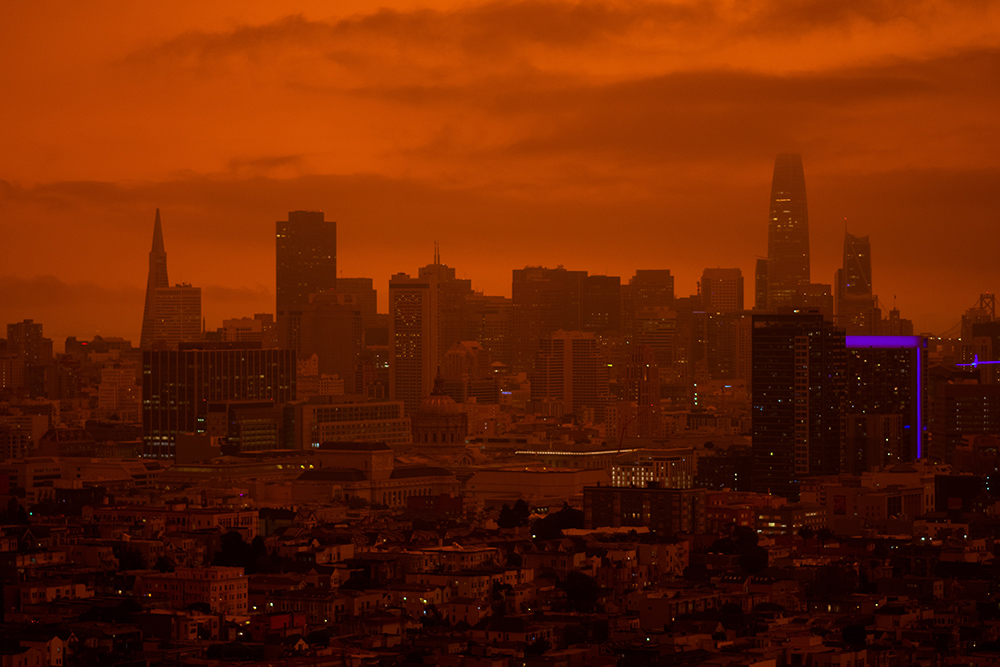 A city landscape shrouded in a red haze.